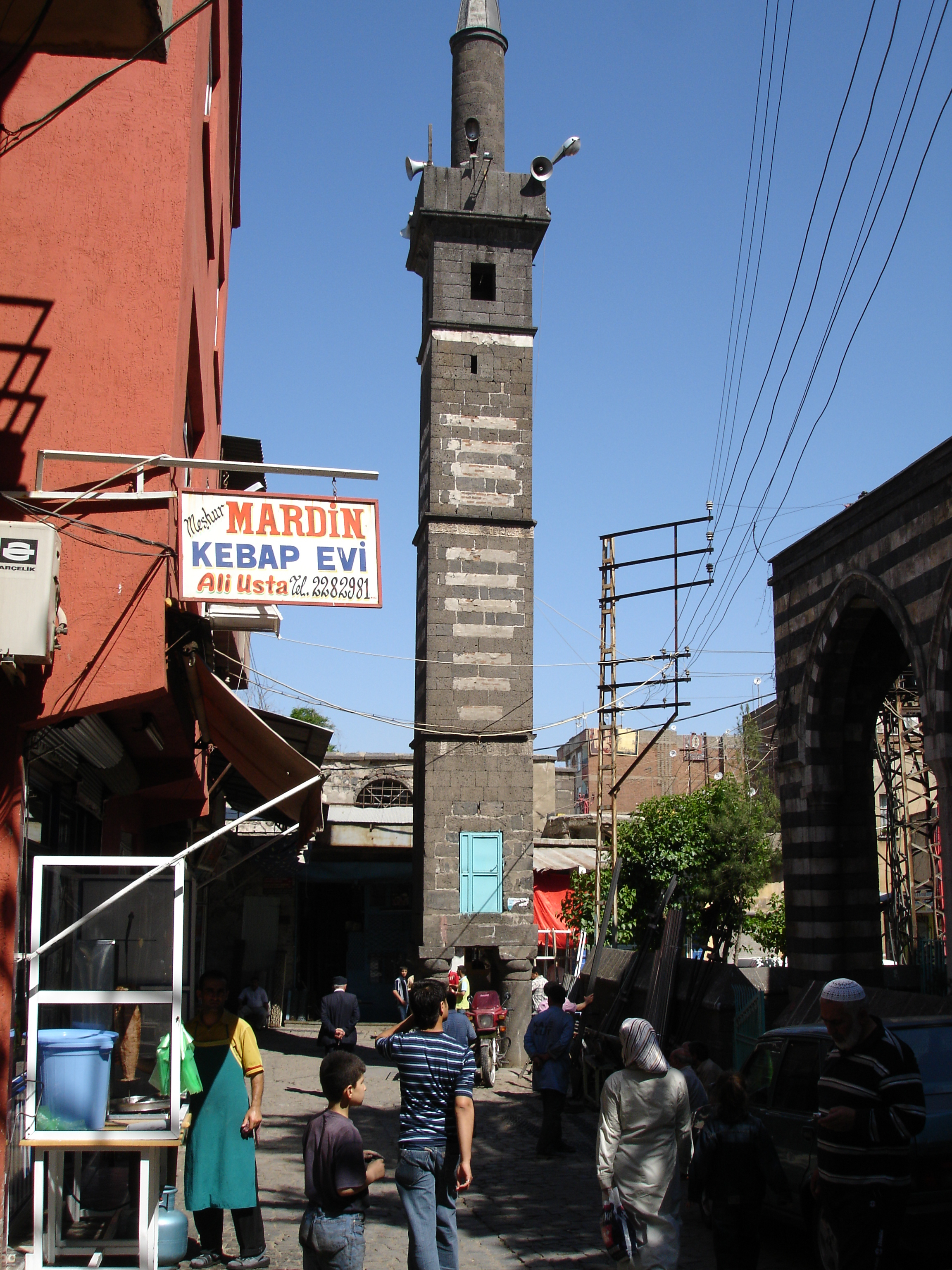 Square stone tower of the Four-Legged Minaret standing on columns in a Diyarbakır street, photographed in 2006